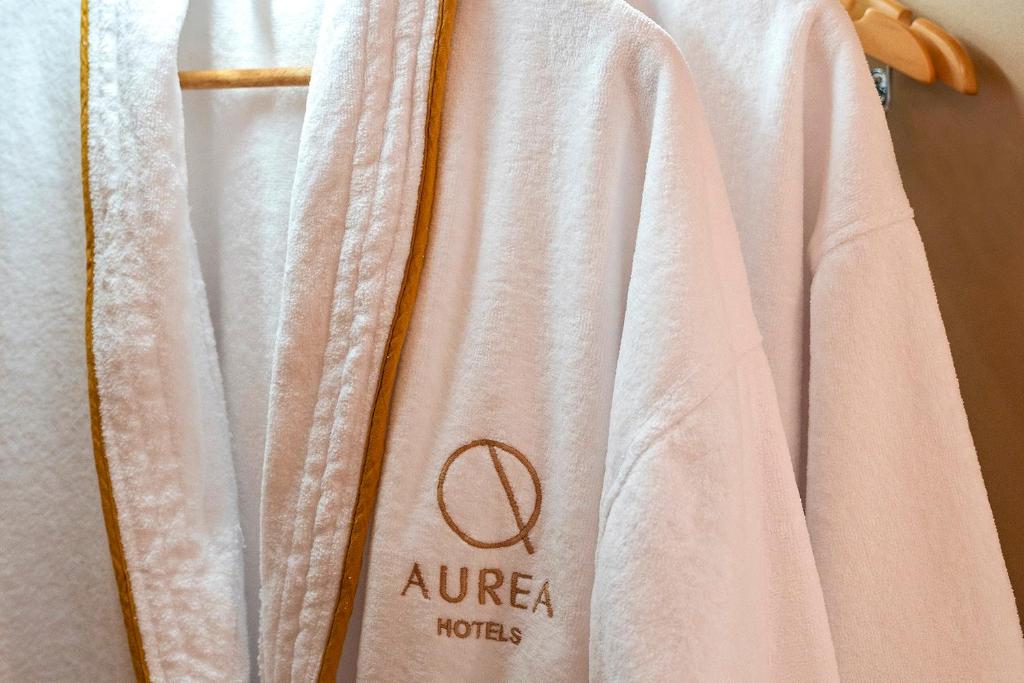 a white robe hanging on a towel rack at Áurea Casa Palacio Sagasta by Eurostars Hotel Company in Cádiz