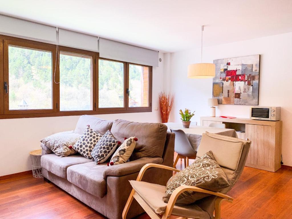 a living room with a couch and a table at Apartamento Font Blanca en Arinsal in Mas de Ribafeta
