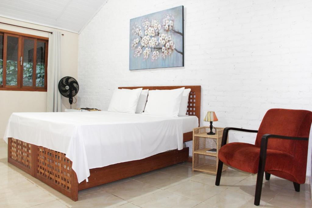 Uma cama ou camas num quarto em Pousada Vale Du'Carmo