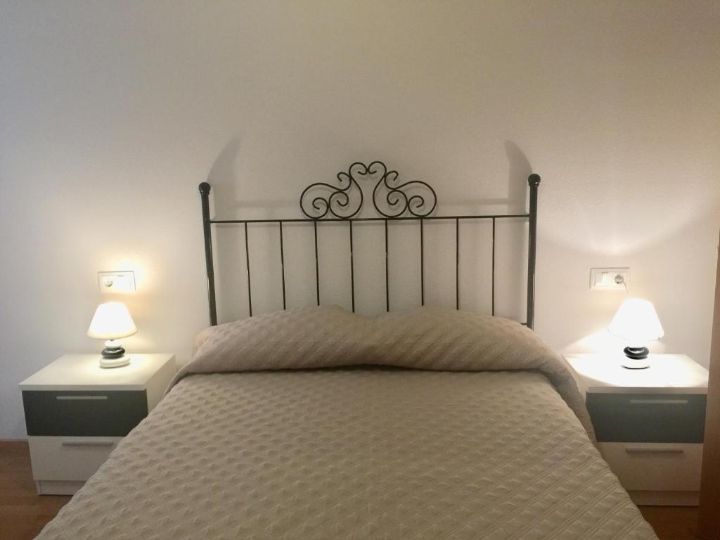 Кровать или кровати в номере Apartamentos Arcos Costa Cálida