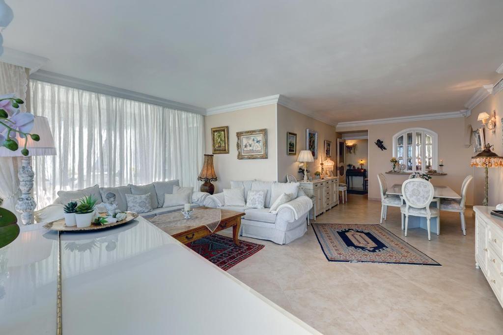 a living room with a couch and a table at Malaga Paradise Home in Torremolinos