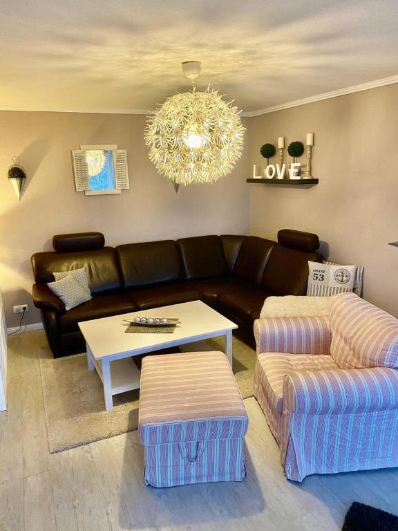 a living room with a couch and a table at Seeschloss Wohnung 22 in Dahme