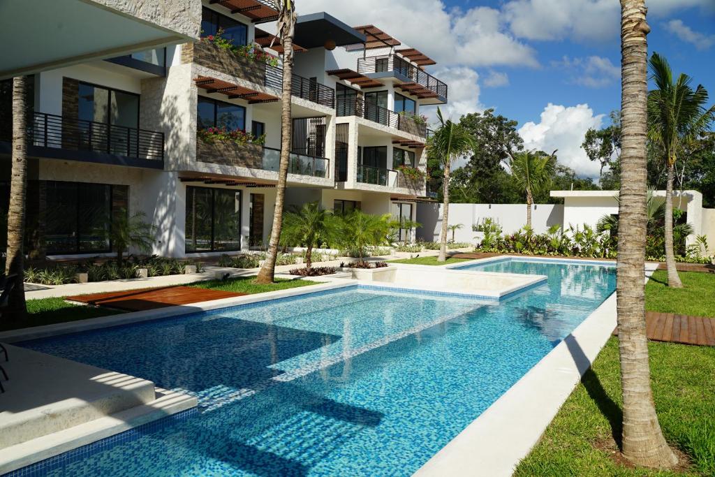 an image of a swimming pool in front of a building at Kaanal Tulum in Tulum