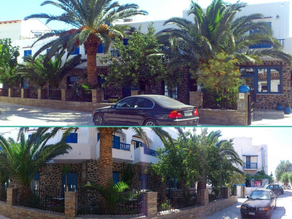 un'auto parcheggiata di fronte a un edificio con palme di Foinikas Studios a Mérichas