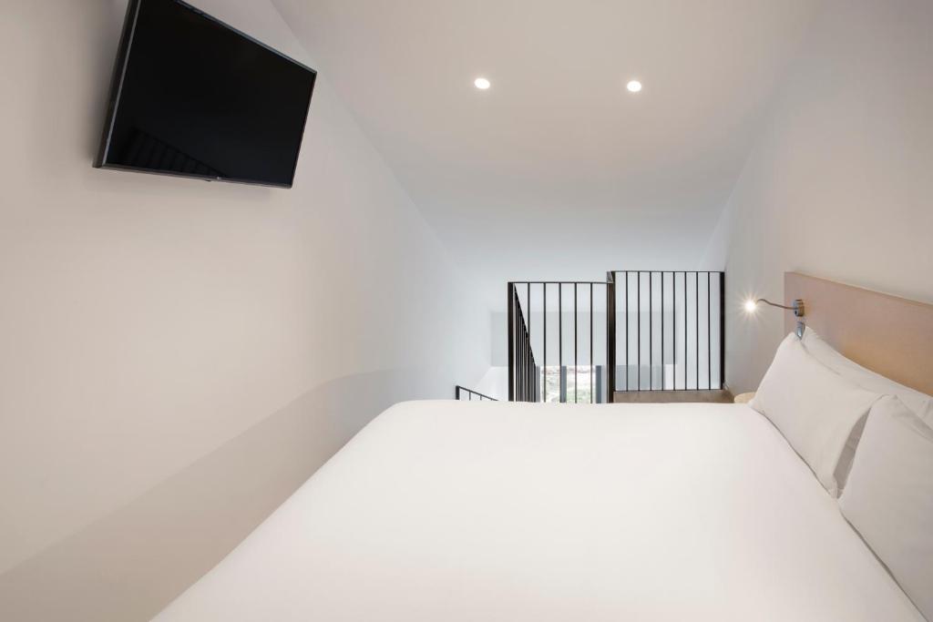 Posteľ alebo postele v izbe v ubytovaní B&B HOTEL Málaga Centro