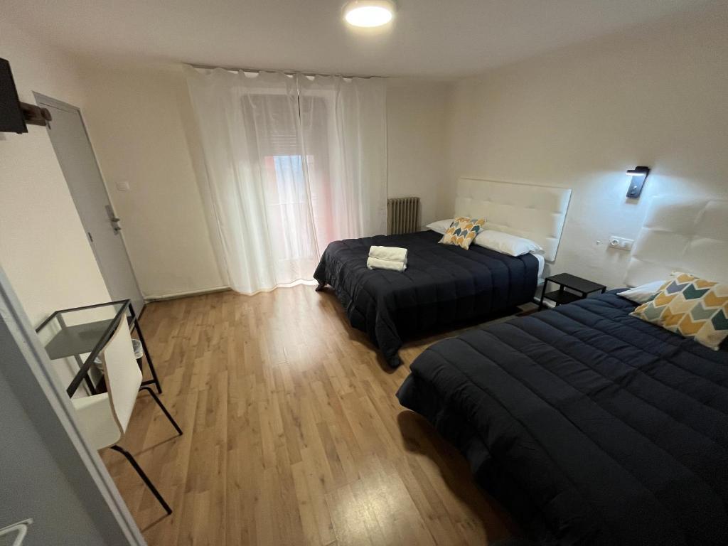 Posteľ alebo postele v izbe v ubytovaní Hostal ARS