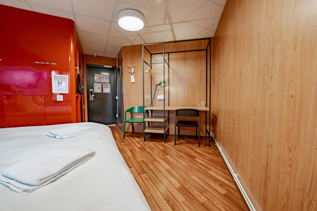 a room with a bed and a table and chairs at Generator Stockholm in Stockholm