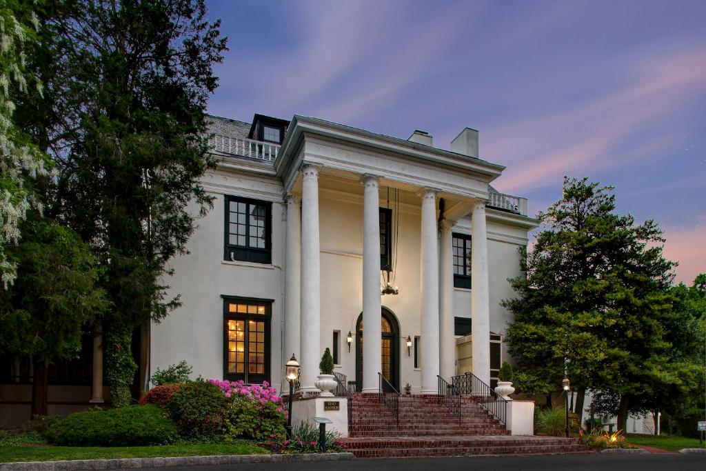 a large white house with columns and a porch at Tarrytown House Estate on the Hudson in Tarrytown