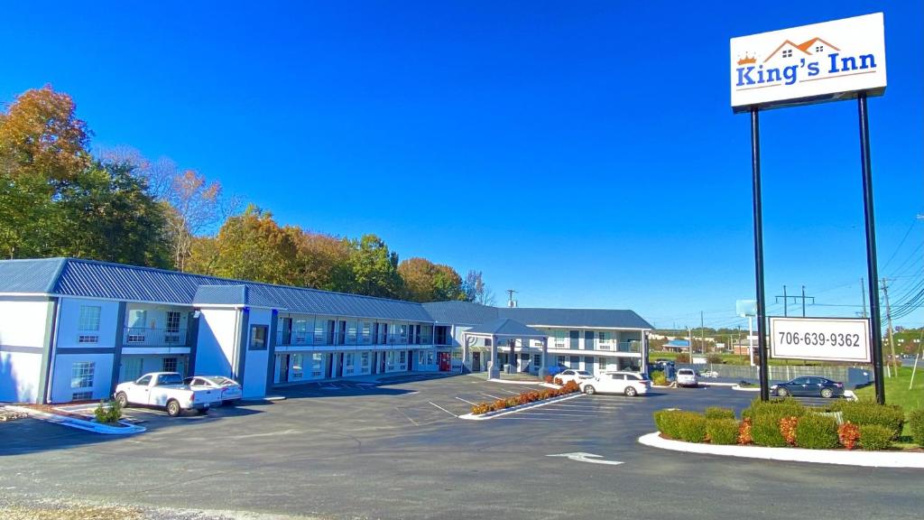 a large building with cars parked in a parking lot at KINGS INN in LaFayette