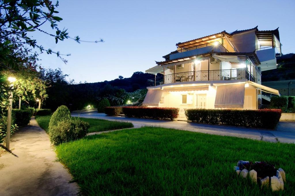 a large building with lights on top of a yard at Thea Studios in Finikounta