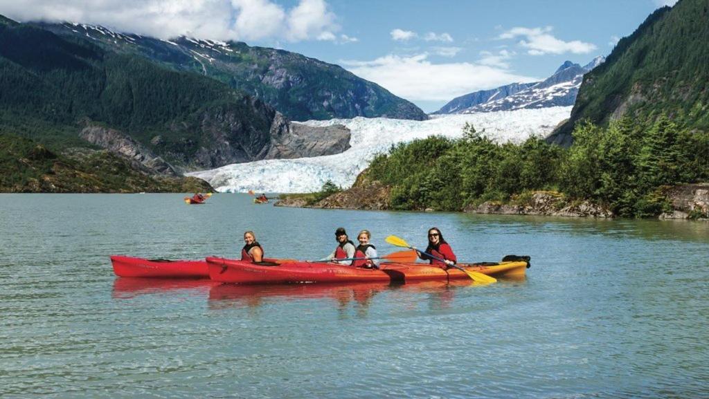 a group of people in a red kayak on a lake at High Grade - Affordable, Near Mendenhall Glacier, Trails, and Conveniences -DISCOUNT ON TOURS! in Mendenhaven