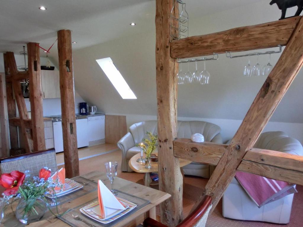 a dining room and living room with a loft bed at Ferienwohnung NH5 in Hirschburg