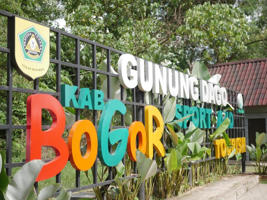 a fence with the guangzhou dog park sign at Gunung Dago Resort Bogor Syariah in Bogor