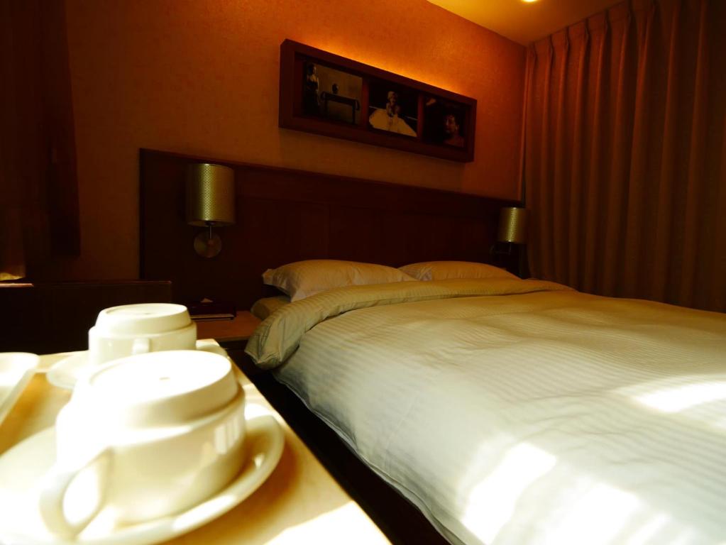 Postel nebo postele na pokoji v ubytování 東鑫商務旅館Eastern Star Hotel