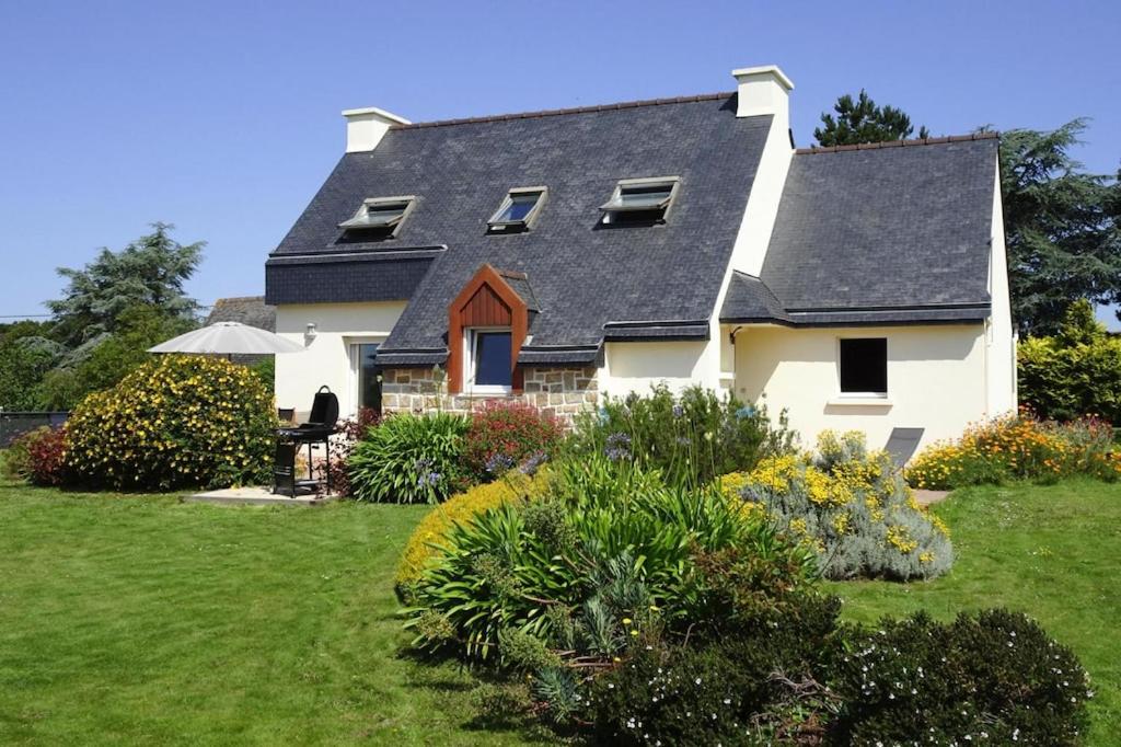 a white house with a black roof at Holiday Home in Paimpol near Beach in Paimpol