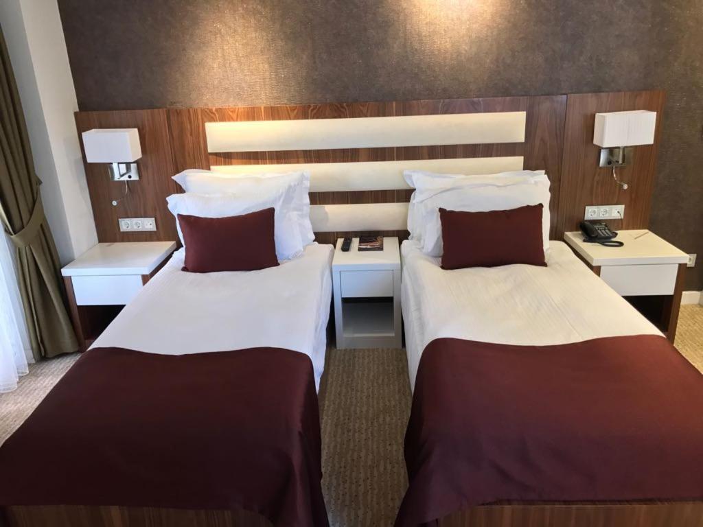 Postel nebo postele na pokoji v ubytování Endglory Hotel