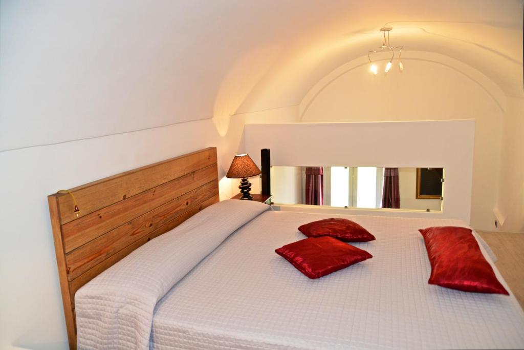a bedroom with a bed with red pillows on it at B&B Torre Porta Marina in Ventimiglia