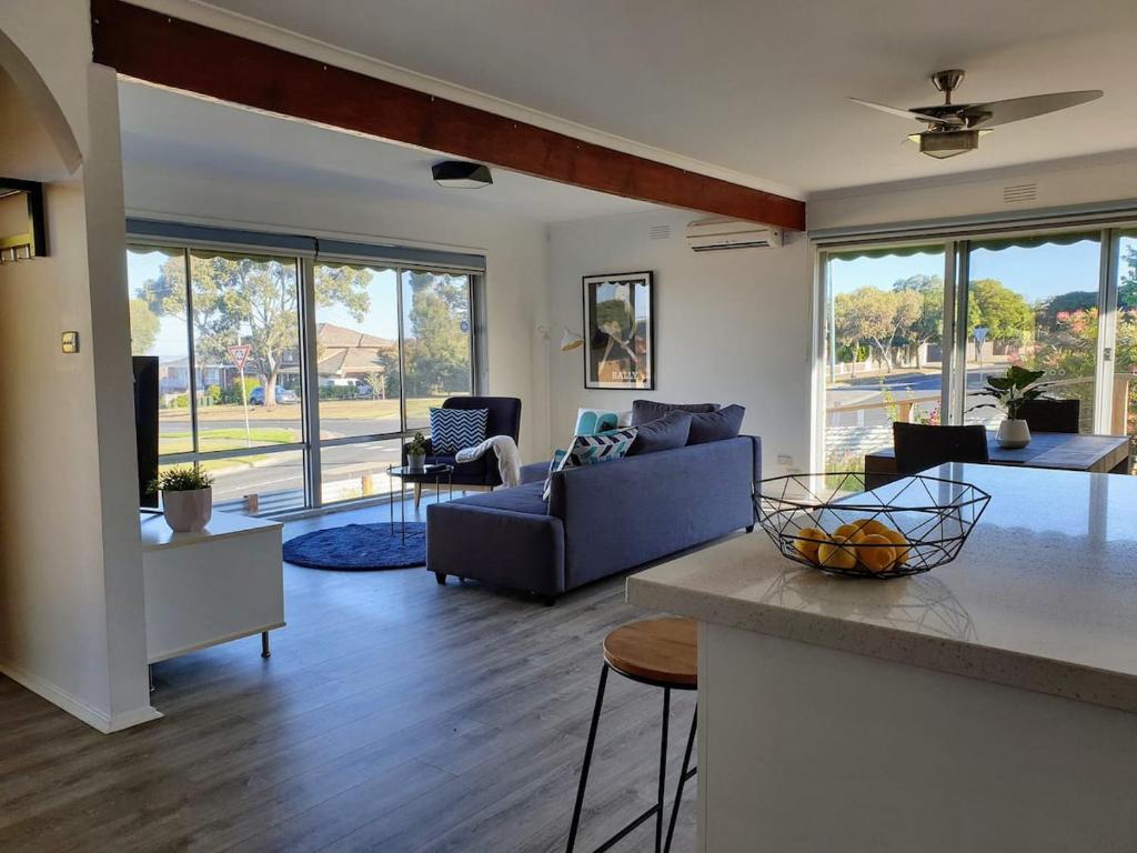 a living room with a couch and a table at Homely Getaway in Bell Post Hill in Norlane