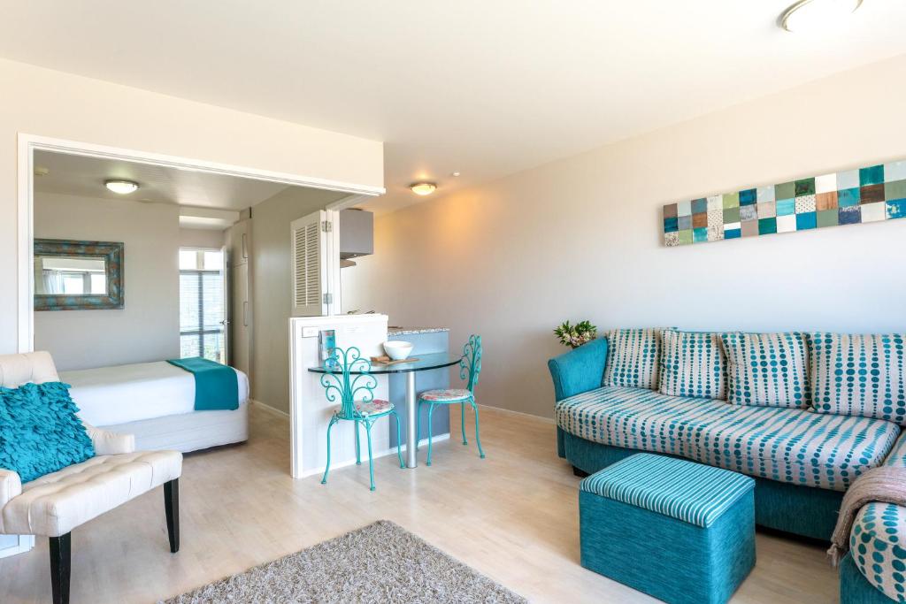 uma sala de estar com um sofá e uma mesa em Oneroa Bay Villas em Oneroa