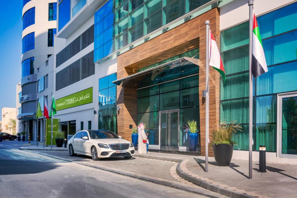 a car parked in front of a building at Springfield Suites in Seef