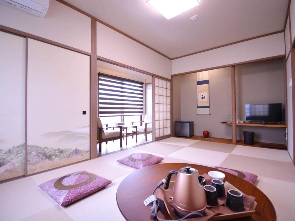 a room with a table with a tea kettle on it at Daigo - Vacation STAY 04957v in Kanayama