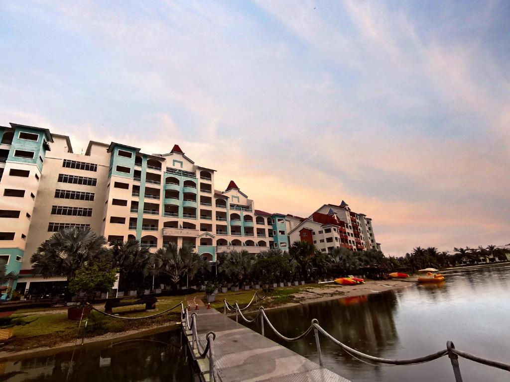 a city with tall buildings next to a body of water at Marina Island Lumut HomeHotel in Lumut