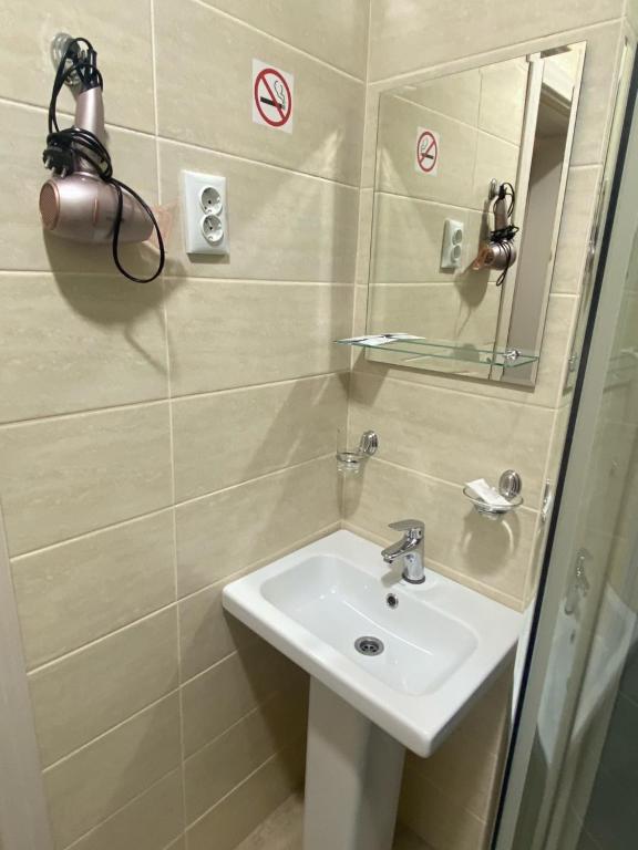 a bathroom with a sink and a mirror at Гостиница "Талисман" in Barnaul