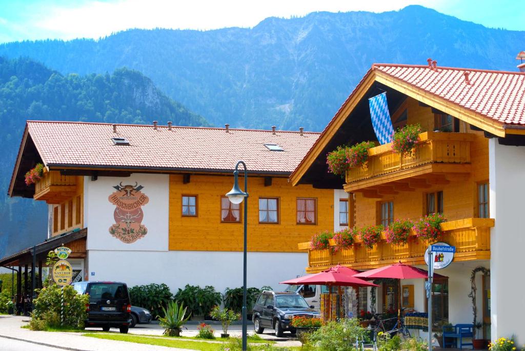 a building with a sign on the side of it at Gasthof-Metzgerei Hirschbichler - Chiemgau Karte in Inzell