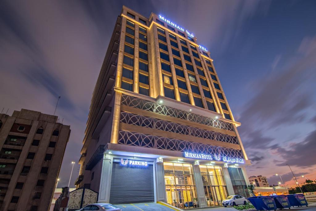 a tall building with a sign on top of it at Mirnian Hotel in Jeddah