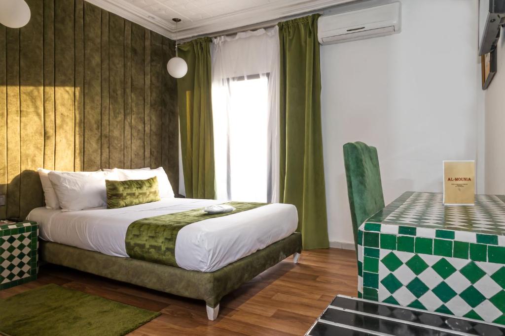 a hotel room with a bed and a window at Hotel Majestic in Casablanca