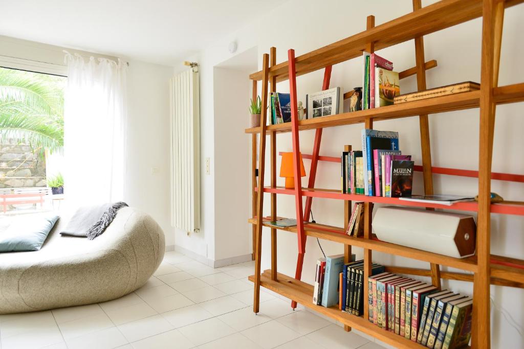 a room with a book shelf filled with books at L’appartement - Jardin Secret in Marseille
