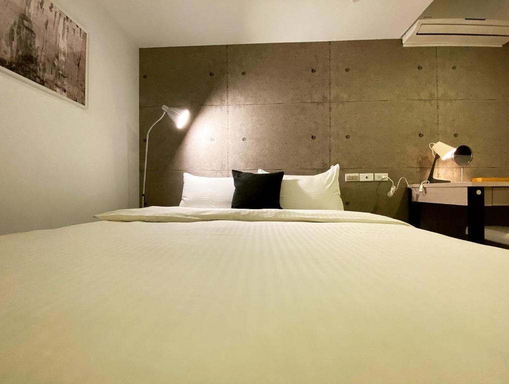 Postel nebo postele na pokoji v ubytování M Taipei Hotel
