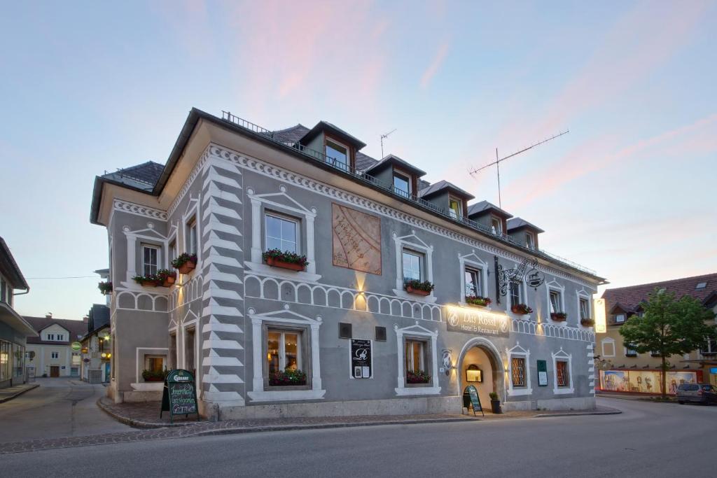 a large white building on the side of a street at Hotel Restaurant DAS RÖSSL in Windischgarsten