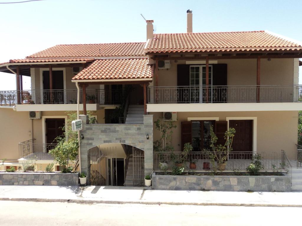 a house with a tile roof at Erminia Studios in Mousata