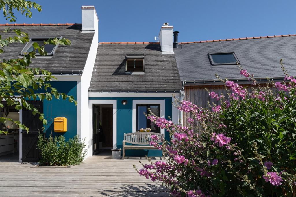 ein blaues Haus mit einer Bank davor in der Unterkunft Les Chambres d'Hôtes de Bordustard in Le Palais
