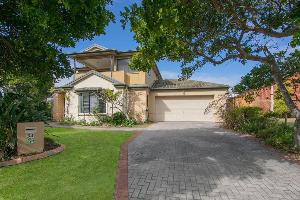 a house with a driveway and a garage at Oceania Peace in Yamba
