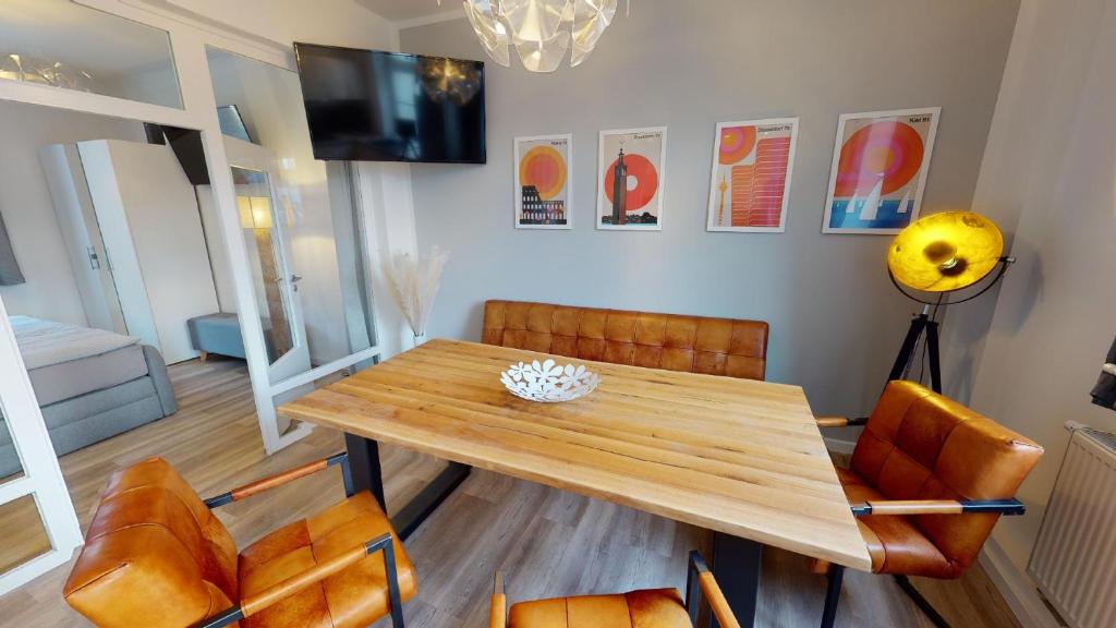 a dining room with a wooden table and chairs at Lieblingsapartment No.4 in Top-Citylage mit 2 Schlafzimmern in Rostock