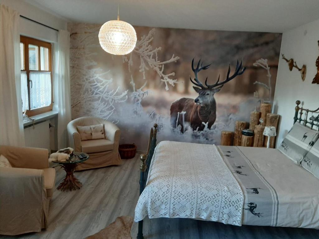 a bedroom with a deer mural on the wall at B&B Neuses am Brand in Sonnefeld