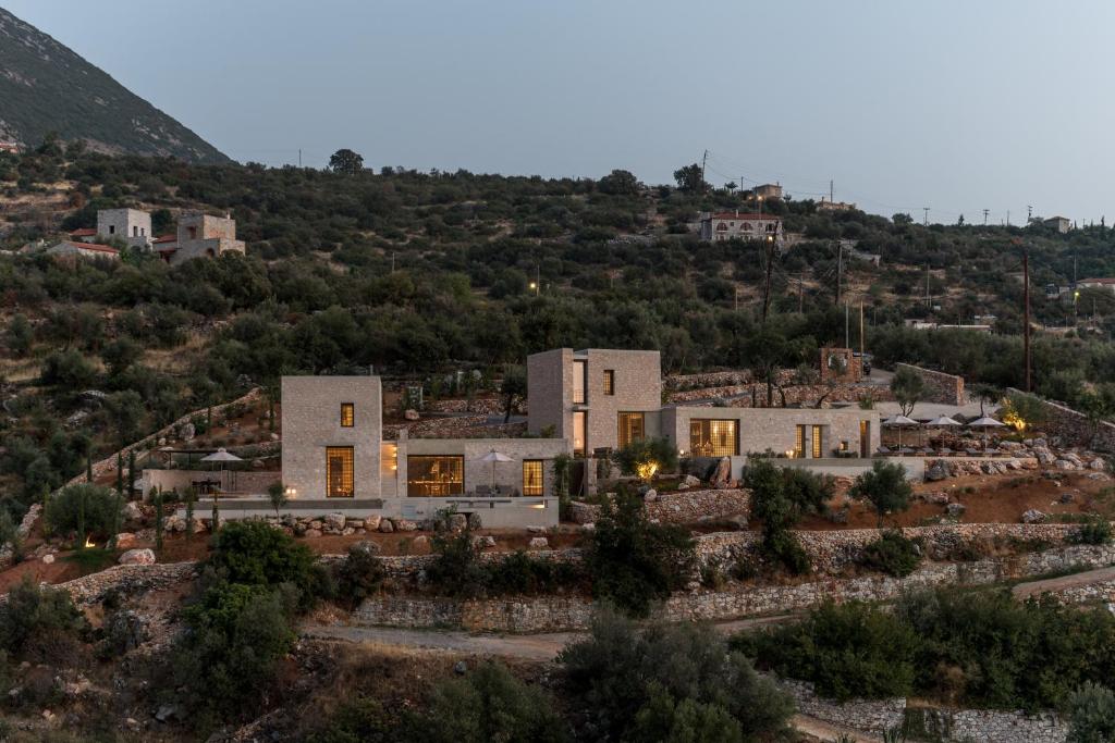 an aerial view of a house on a hill at Monolithoi Villas in Piyí