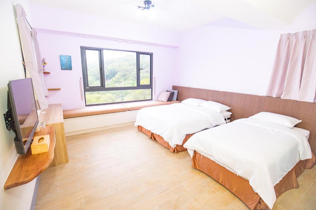 Postel nebo postele na pokoji v ubytování 亞窩行館 Yao Guesthouse
