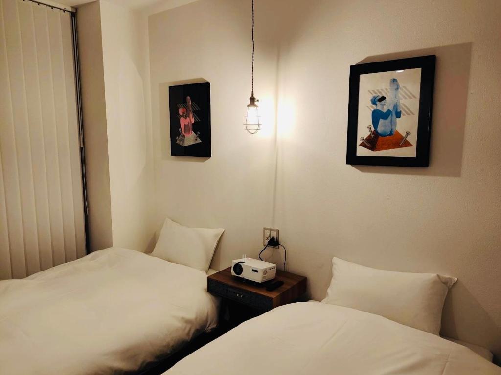 Postel nebo postele na pokoji v ubytování BENJAMIN HOTEL KANAZAWA