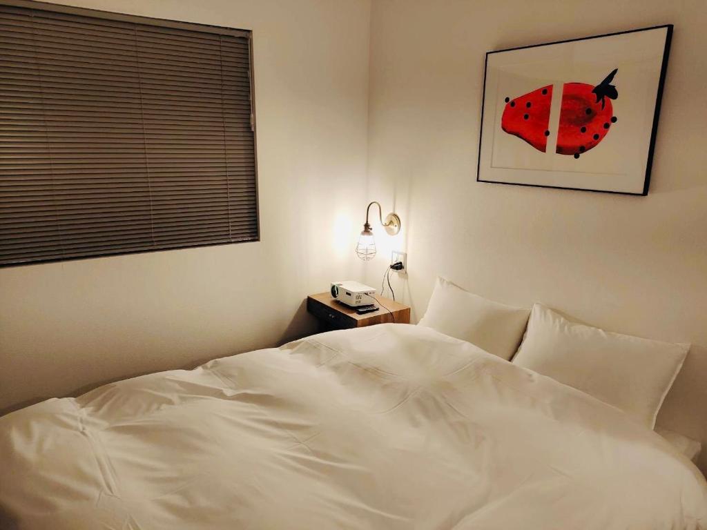 Postel nebo postele na pokoji v ubytování BENJAMIN HOTEL KANAZAWA