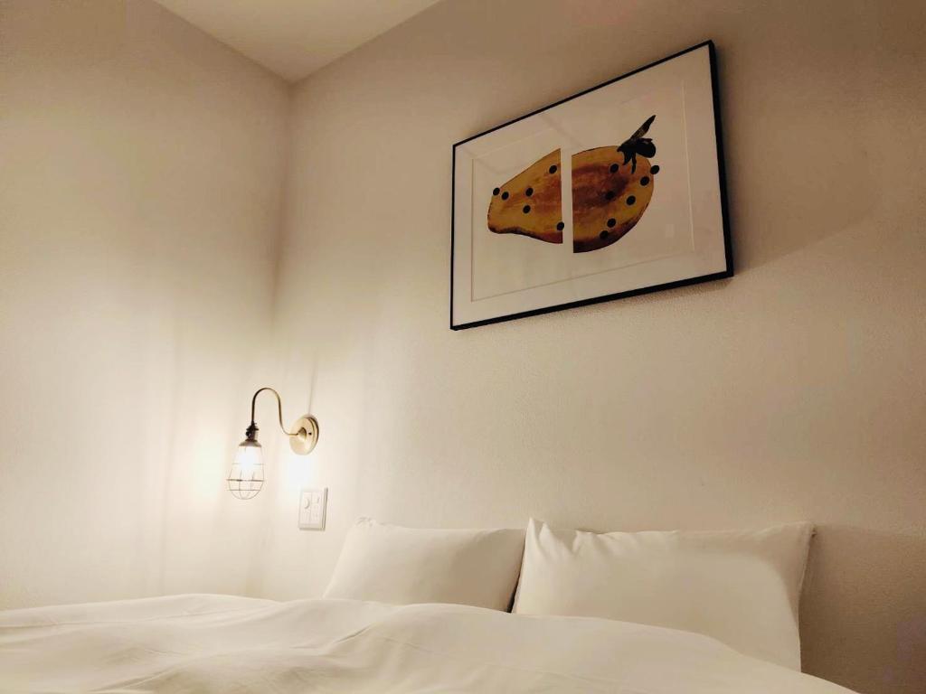 Postel nebo postele na pokoji v ubytování BENJAMIN HOTEL KANAZAWA