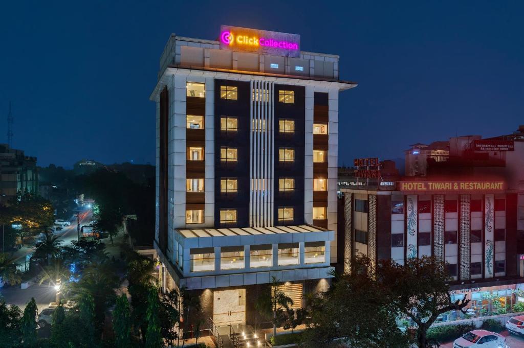 a building with a neon sign on top of it at Click Collection Jaipur in Jaipur