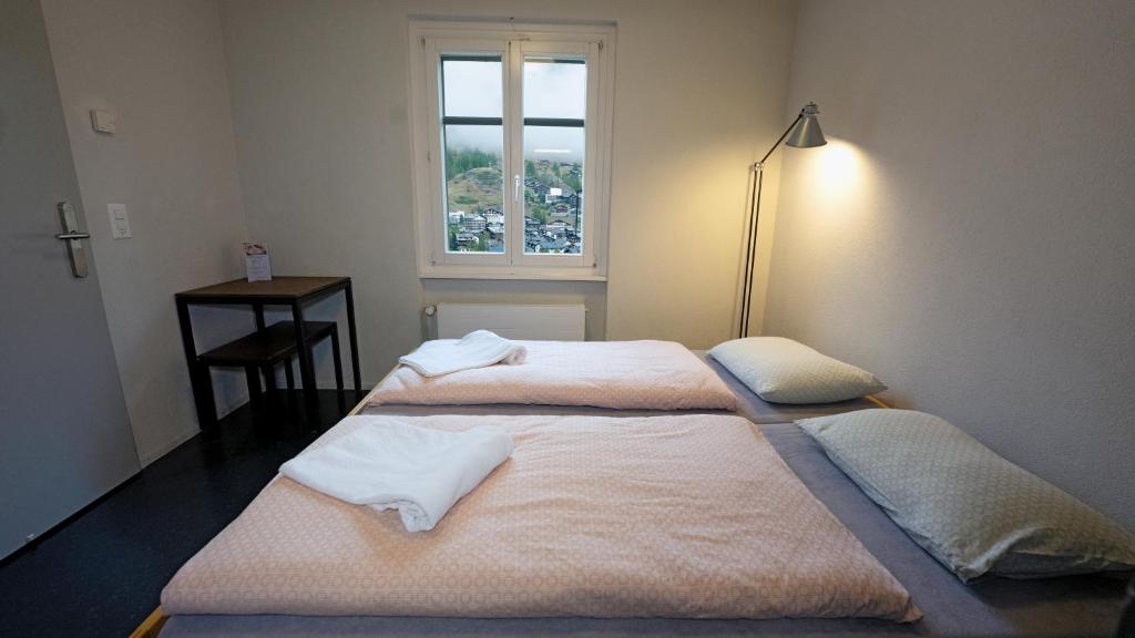 Ein Bett oder Betten in einem Zimmer der Unterkunft Zermatt Youth Hostel