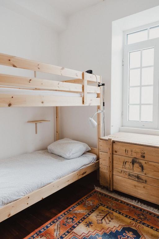 Postel nebo postele na pokoji v ubytování Jaca Hostel Porto da Cruz