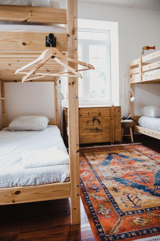 Postel nebo postele na pokoji v ubytování Jaca Hostel Porto da Cruz