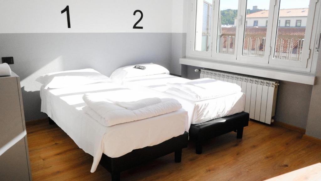 Postel nebo postele na pokoji v ubytování Hotello Hostel