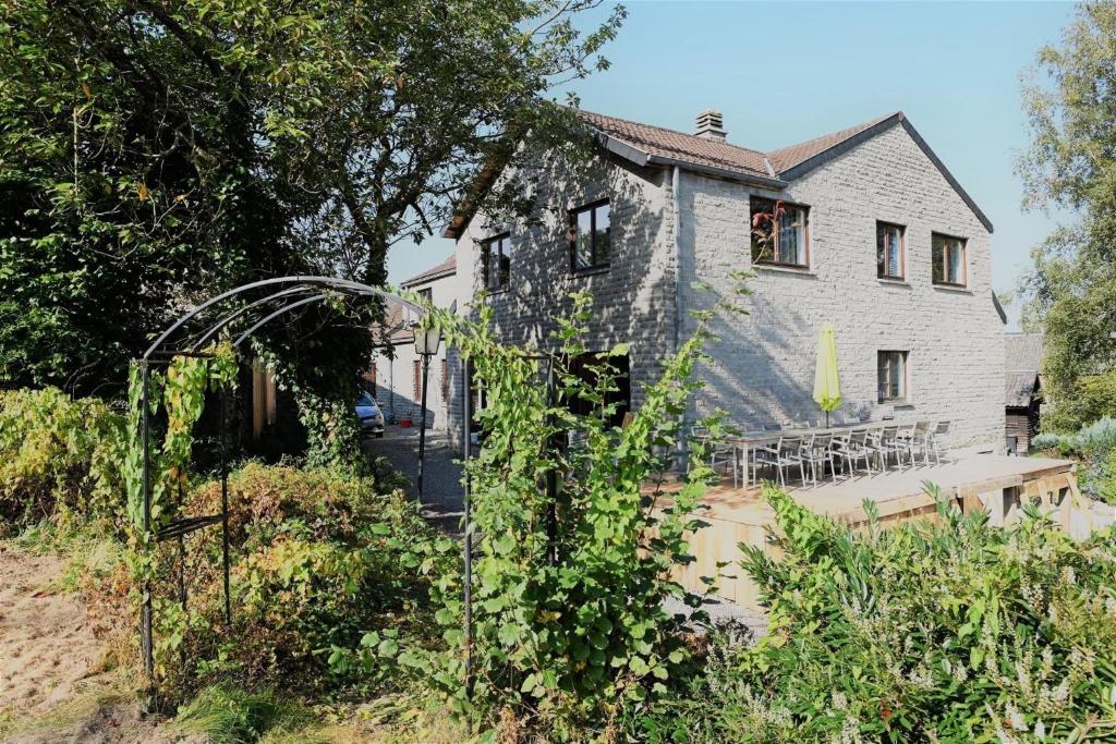 a house with a table and chairs in front of it at Villa Dhoris in Ferrières