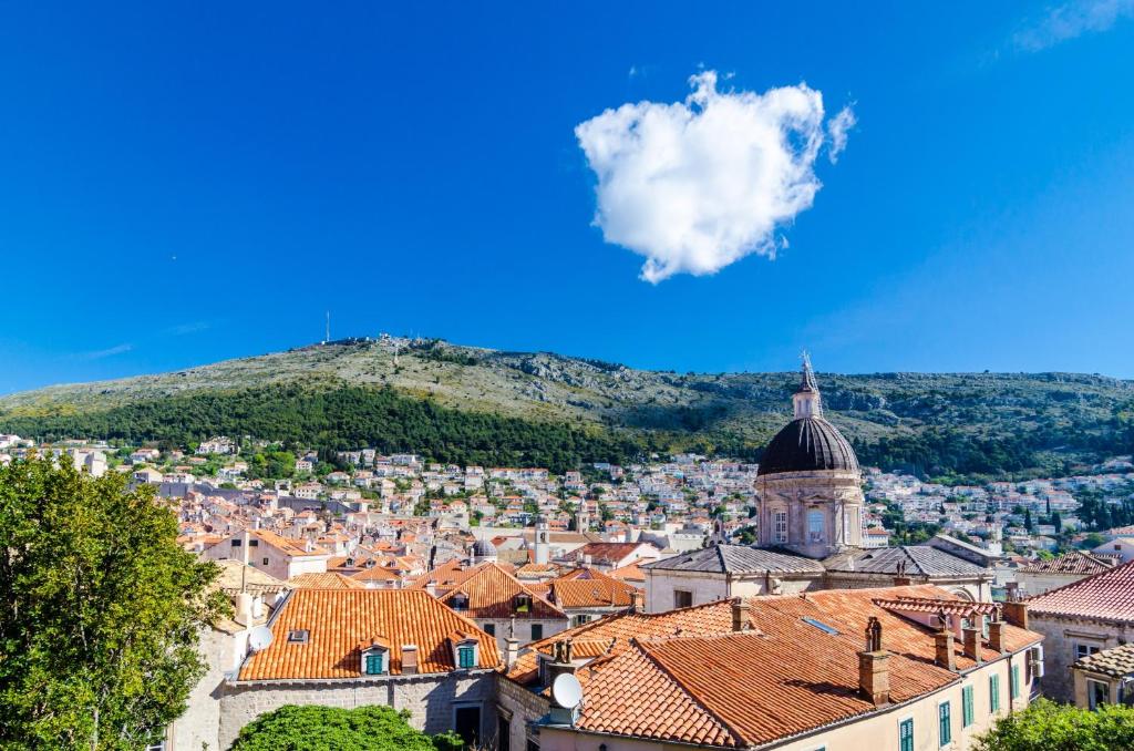 a view of a city with a hill in the background at Rooms Vlaho in Dubrovnik